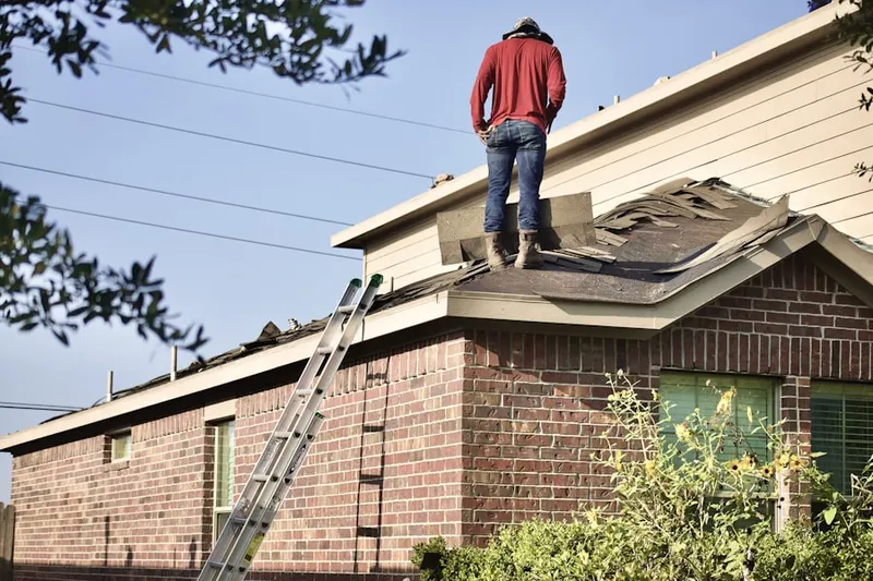 Professional roofer working on a residential roof in Bentwood